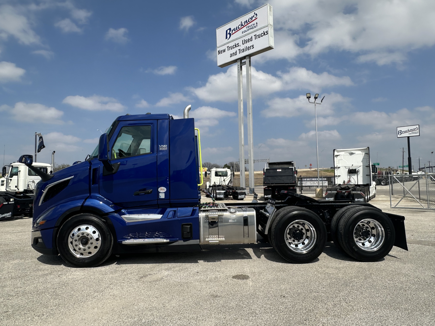 Volvo VNR64T300 truck in blue side view showing cab and chassis with dual rear axles.