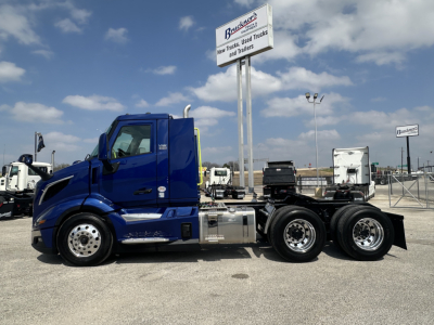 Volvo VNR64T300 truck in blue side view showing cab and chassis with dual rear axles.