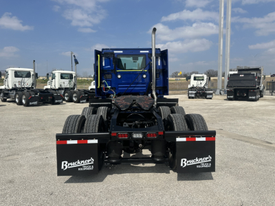 Truck chassis rear view showing fifth wheel and mud flaps with Buckner's Equipment branding.