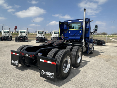 Volvo VNR64T300 truck chassis rear view showing dual rear axles and fifth wheel with mud flaps and Bruckners Equipment branding