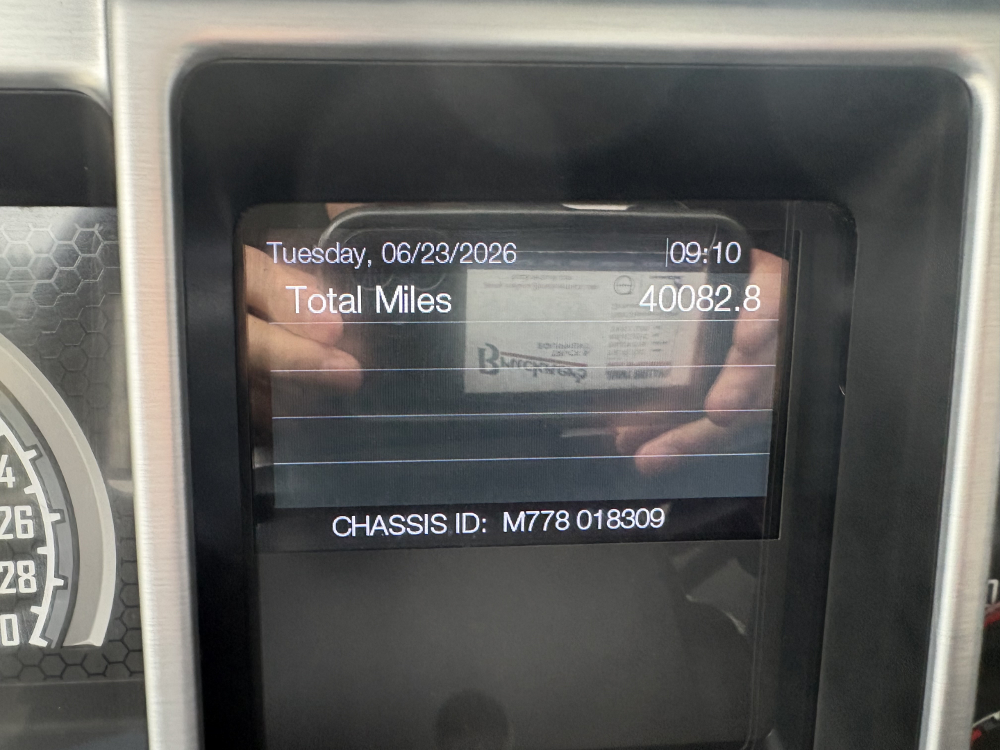Dashboard display showing Total Miles 40082.8, Tuesday 06/23/2026, Chassis ID M778 018309, Mack PI64T information panel.
