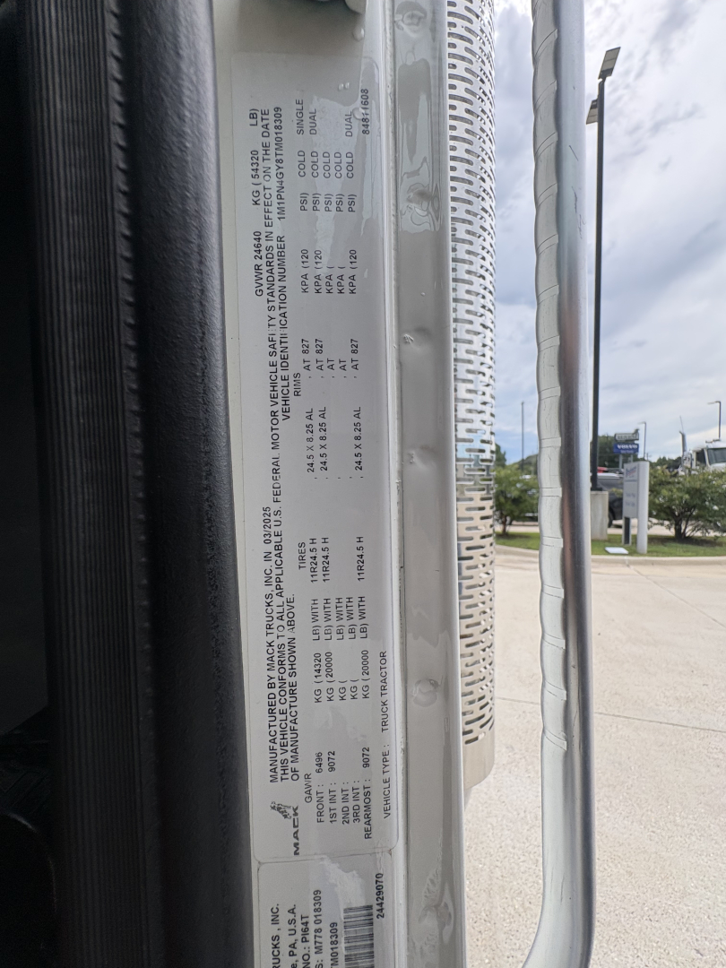 DATAPLATE on Mack chassis showing model year and weight/engine specifications; vertical listing of drivetrain details including VIN and serial numbers.