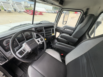 Interior cab view of a new 2026 Mack PI64T conventional daycab showing steering wheel, dashboard, and front seats.