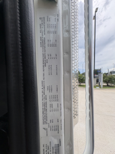 DATAPLATE on Mack chassis showing model year and weight/engine specifications; vertical listing of drivetrain details including VIN and serial numbers.
