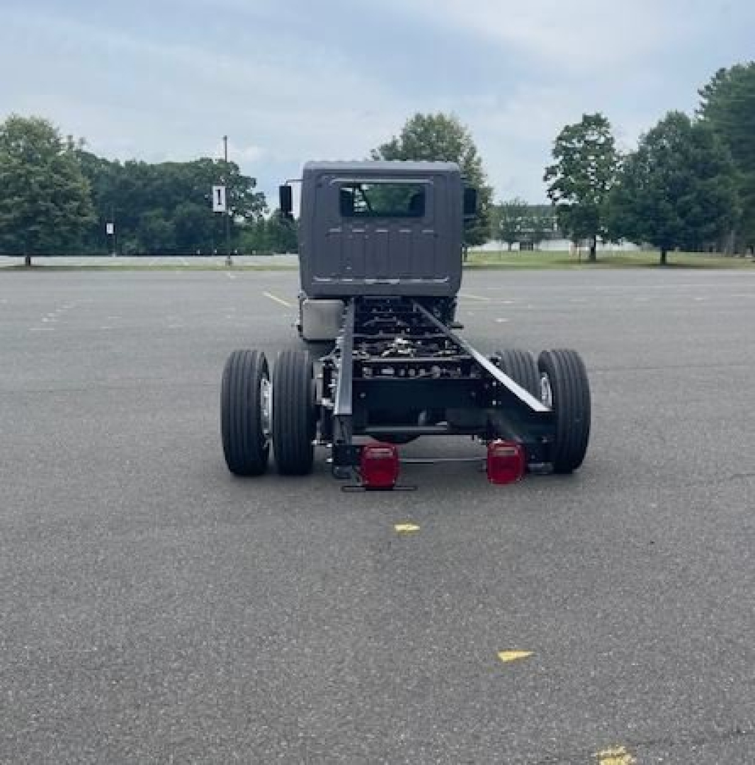 Truck chassis back view showing rear frame, dual rear axles, and spare fuel tanks.
