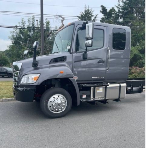 Hino L6 cab chassis truck side view showing fuel tanks and step compartments.