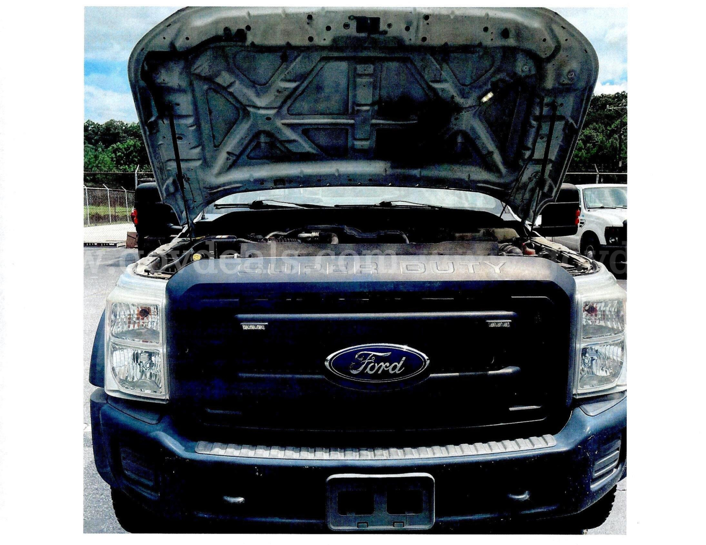 Ford F-450 front view with hood open showing engine bay and Ford emblem.