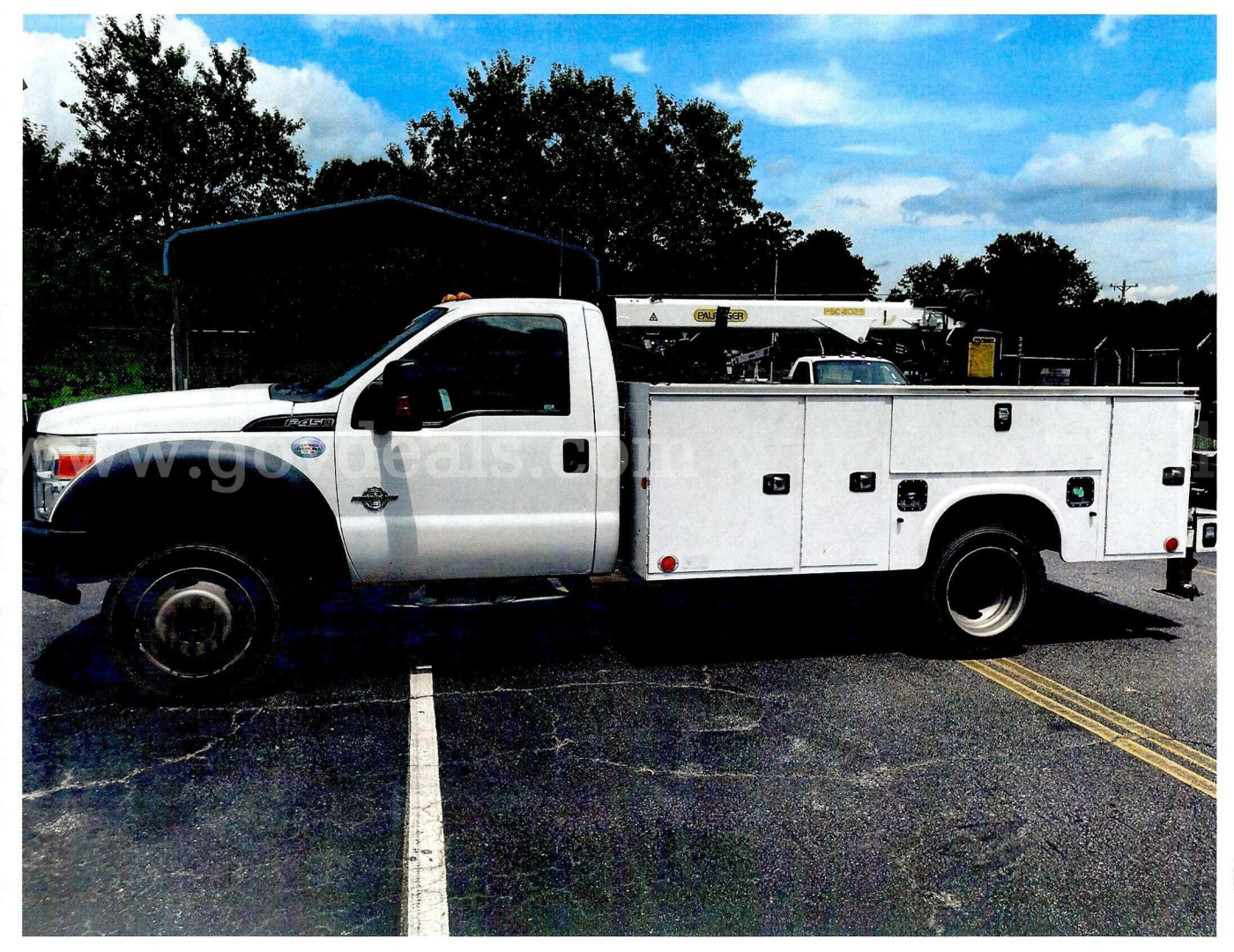 Service/Utility truck showing a white 2016 Ford F-450 utility body with split doors and work compartments, in a parking lot.