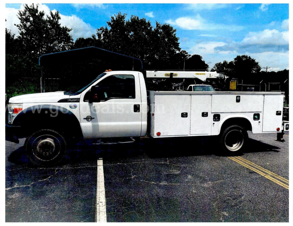 Service/Utility truck showing a white 2016 Ford F-450 utility body with split doors and work compartments, in a parking lot.
