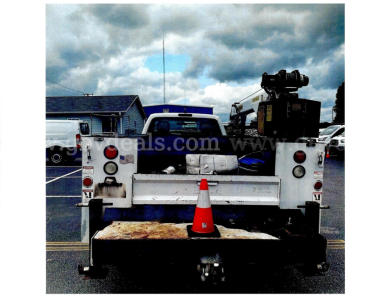 Rear view of a 2016 Ford F-450 service/utility truck showing tow hitch, rear bumper, and utility crane mounted in bed.