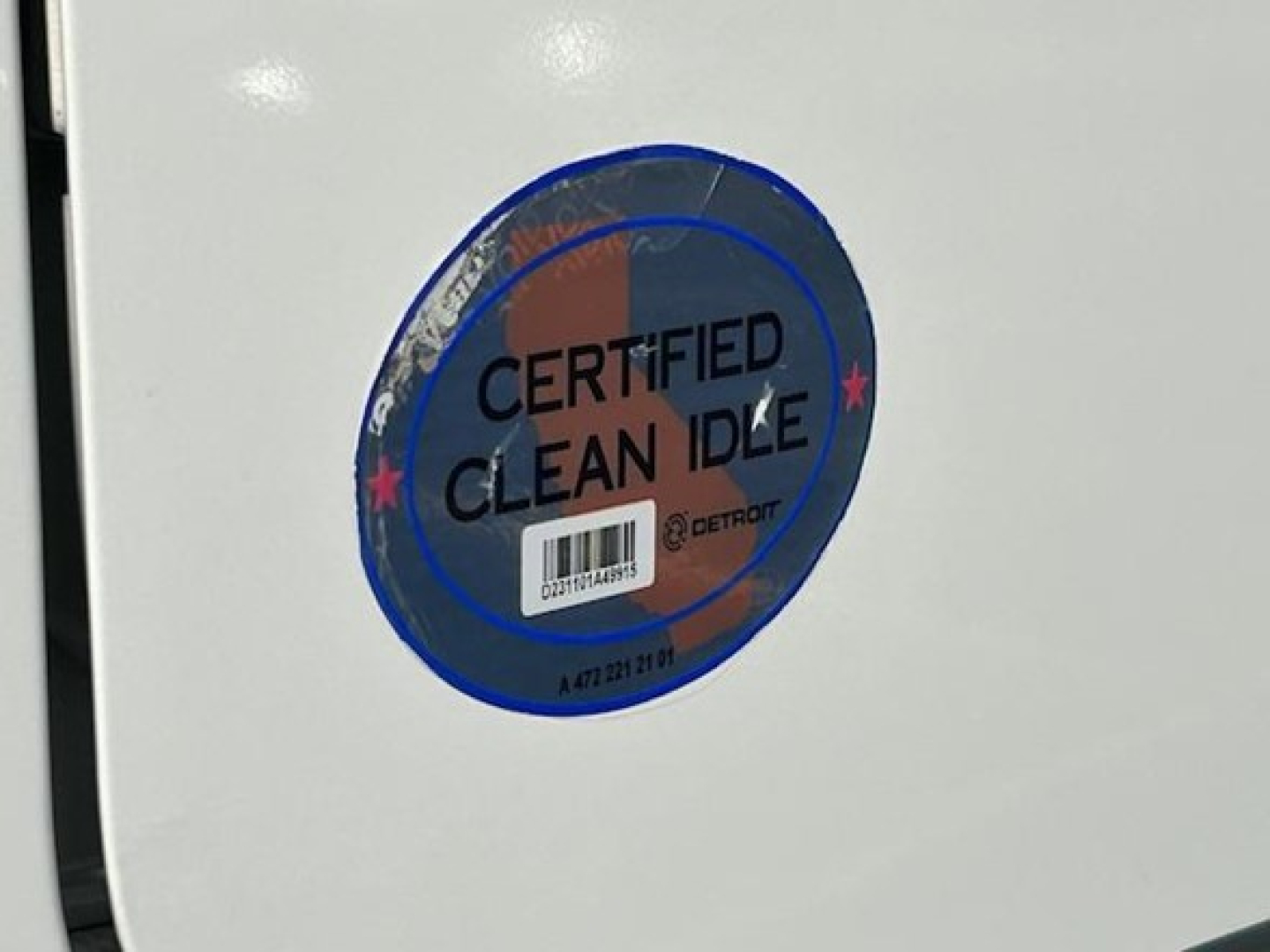 Circle sticker on white surface reading CERTIFIED CLEAN IDLE with DETROIT emblem and barcode.