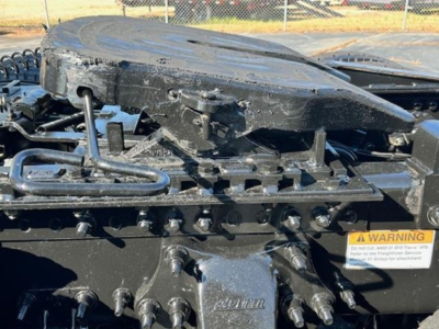 (Component) Tractor cab area showing fifth wheel mounting and valve lines on Freightliner Cascadia 126 rear with warning label and hardware visible.