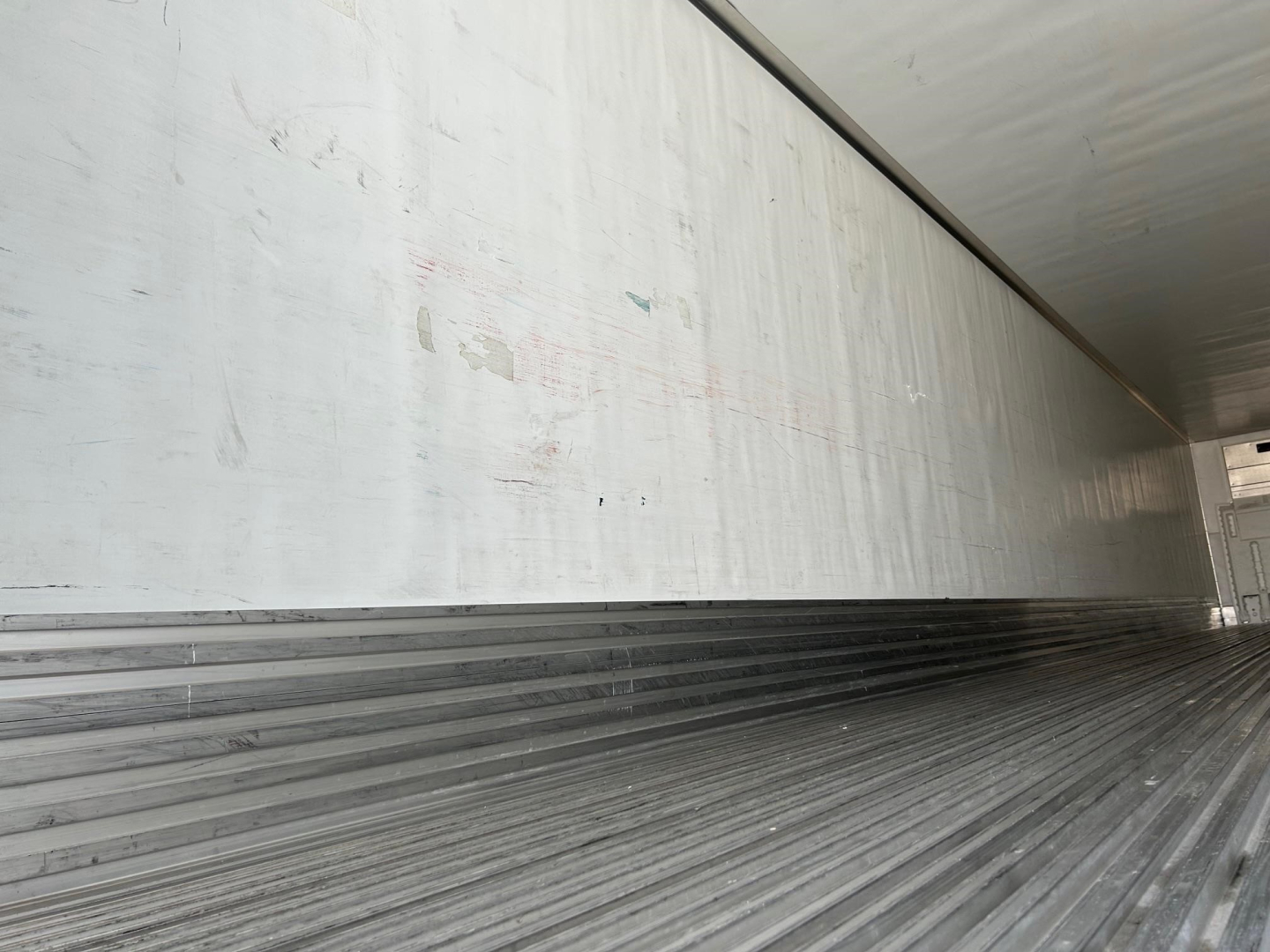 Trailer interior showing corrugated metallic floor and side walls of a 2018 Utility 3000R reefer trailer.