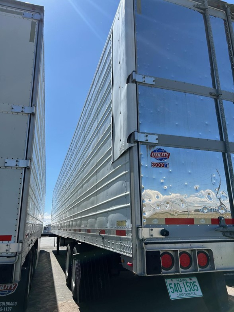 Trailer rear view of a 2018 Utility 3000R reefer trailer showing shiny silver exterior and rear doors with Utility badge.