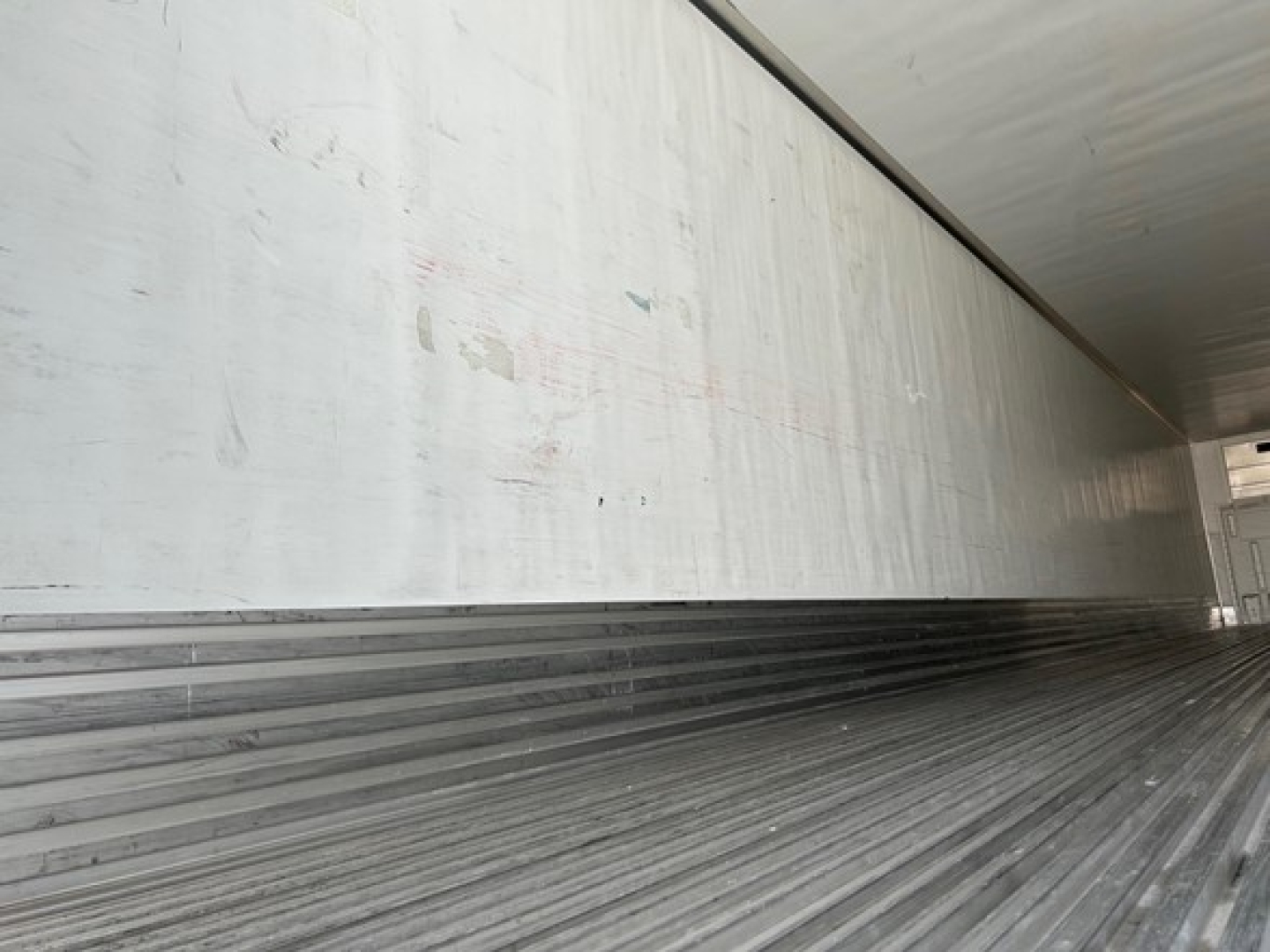 Utility 3000R trailer interior showing corrugated metal floor and side walls with sign of wear