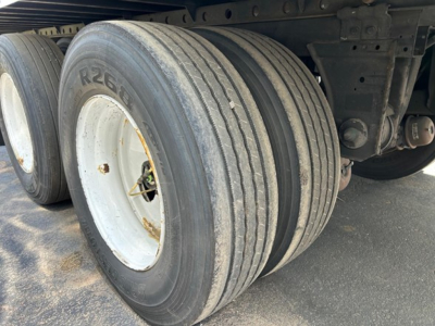 Trailer axles and dual rear tires of a 2018 Utility 3000R reefer trailer showing dual wheels and suspension components.