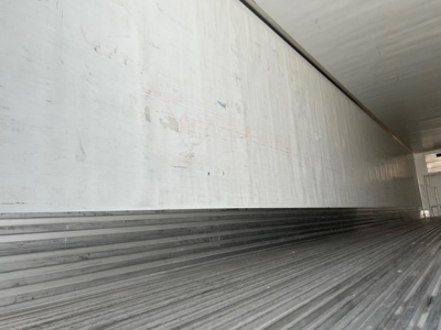 Utility 3000R trailer interior showing corrugated metal floor and side walls with sign of wear
