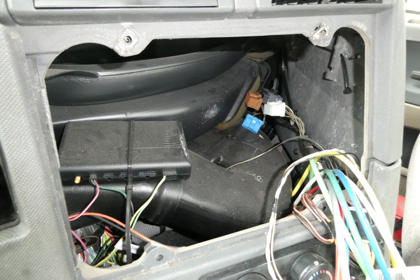 Cab area of a freightliner Cascadia 125 engine bay with exposed wiring harness and diagnostic connectors.