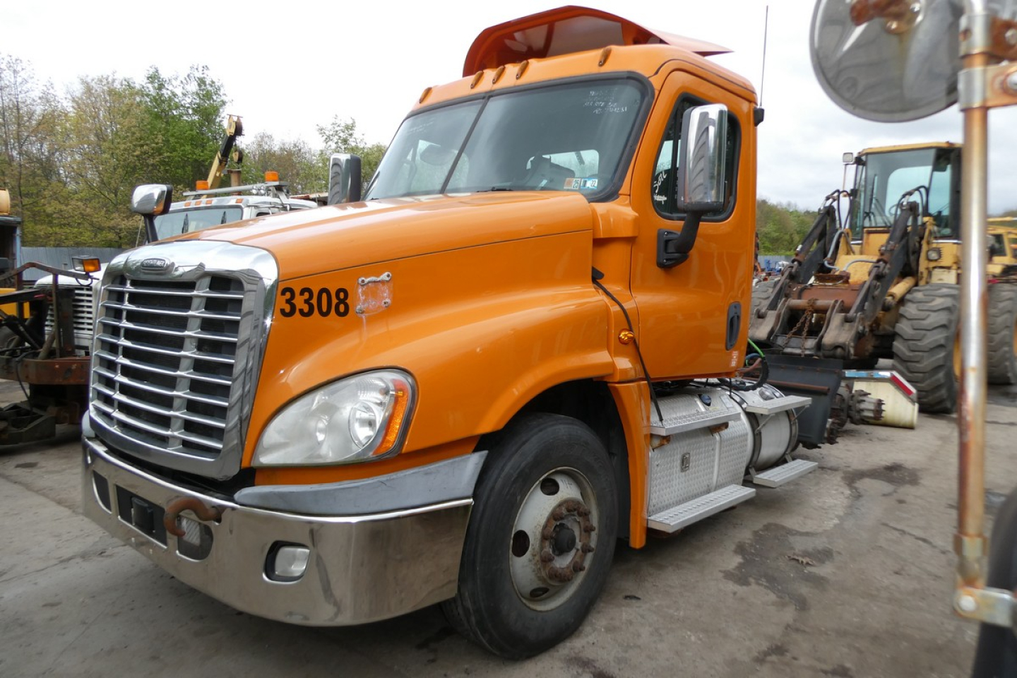 Truck front-left view of a orange Freightliner Cascadia 125 daycab with number 3308, chrome bumper, and step rails.