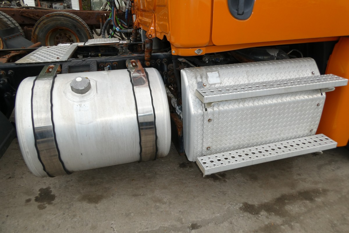Freightliner Cascadia 125 side fuel tanks and aluminum toolbox with diamond plate steps.