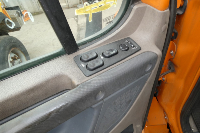 Freightliner Cascadia 125 truck interior door panel with window controls and mirrors switch cluster.