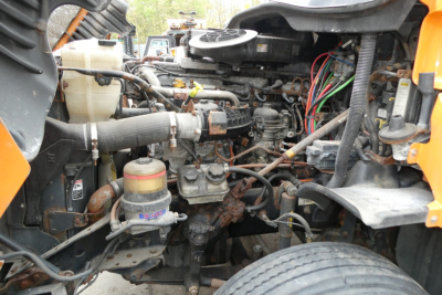 Engine bay of a 2017 Freightliner Cascadia 125 conventional daycab showing engine components, hoses, and fluid reservoirs.