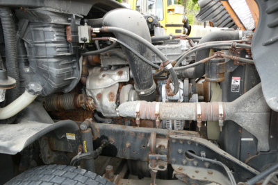 Engine bay and drivetrain components of a 2017 Freightliner Cascadia 125 Daycab showing hoses, turbo, and piping.