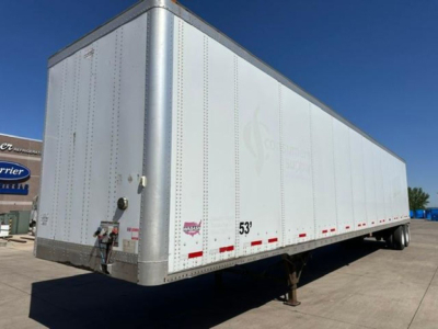 Trailer side view showing a white 53' Wabash van trailer with silver front corner posts and reflective striping.