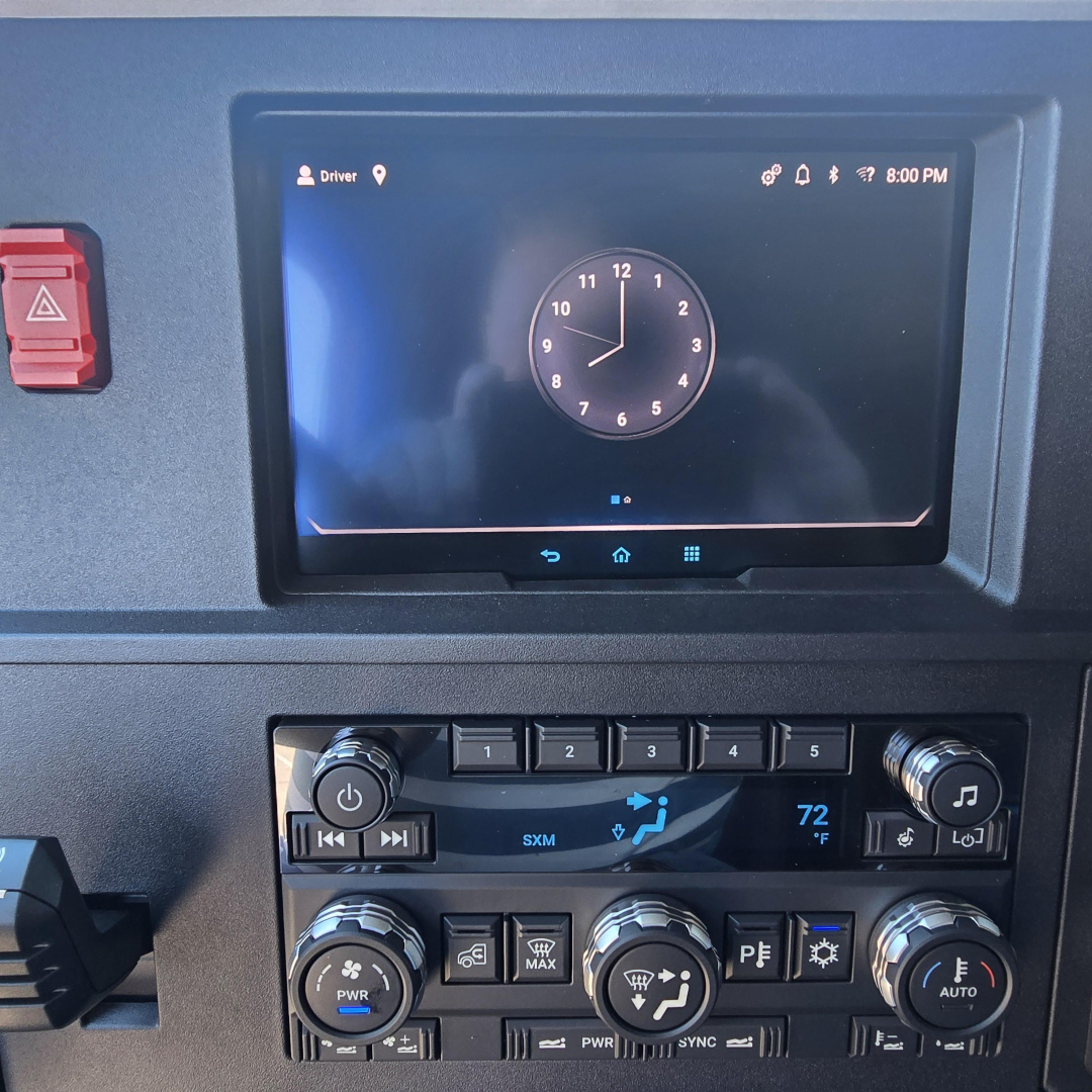 Dashboard display of a 2026 Mack PR64T76H truck showing a touchscreen infotainment unit with a clock, climate controls, and various buttons.