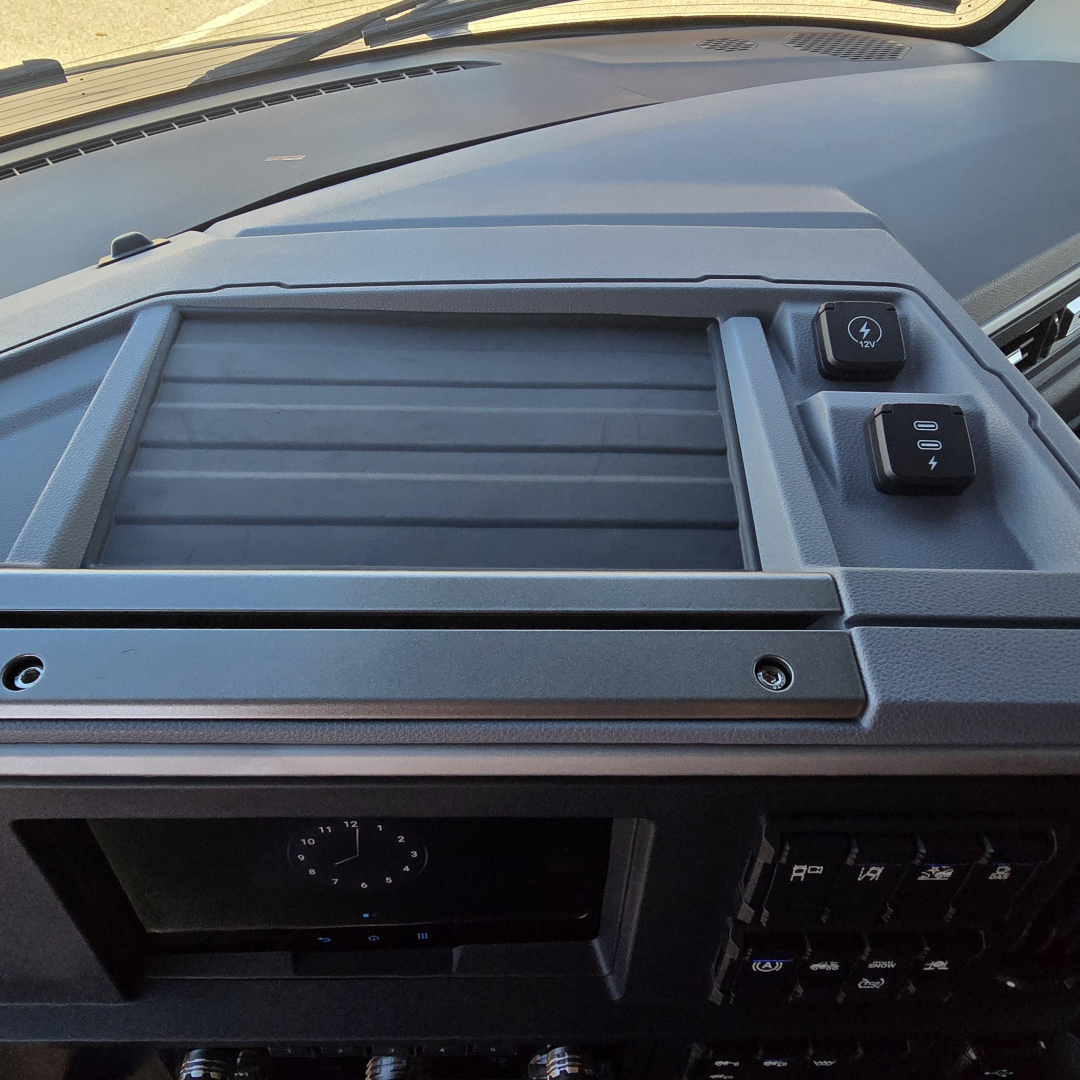 Dashboard view of 2026 Mack PR64T76H showing HVAC vent area and control switches.