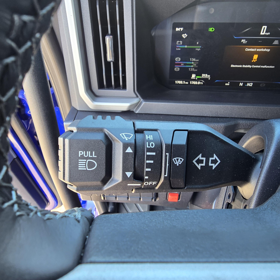 Mack PR64T76H truck interior controls: headlight pull switch labeled PULL, wiper stalk with icons, and dashboard display visible.