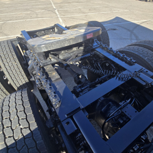 Mack PR64T76H chassis and fifth wheel mount showing drive train frame and hoses.