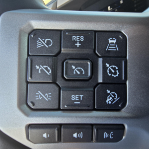 Truck steering wheel controls showing cruise control and lane-keeping icons.