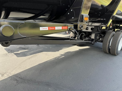 Trailer undercarriage showing front frame and mud flaps with Ranco labels; side view of quarter frame end dump trailer with black paint and chrome components.