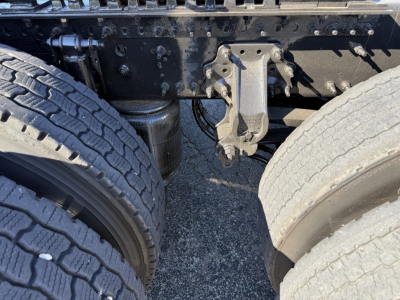 Truck chassis underside showing suspension hangers and dual rear wheels on a Volvo VNL64T760 in-service status.