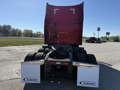 Truck cab back view of a 2021 Volvo VNL64T760 showing rear sleeper, dual rear axles, and mud flaps with MHC logos.