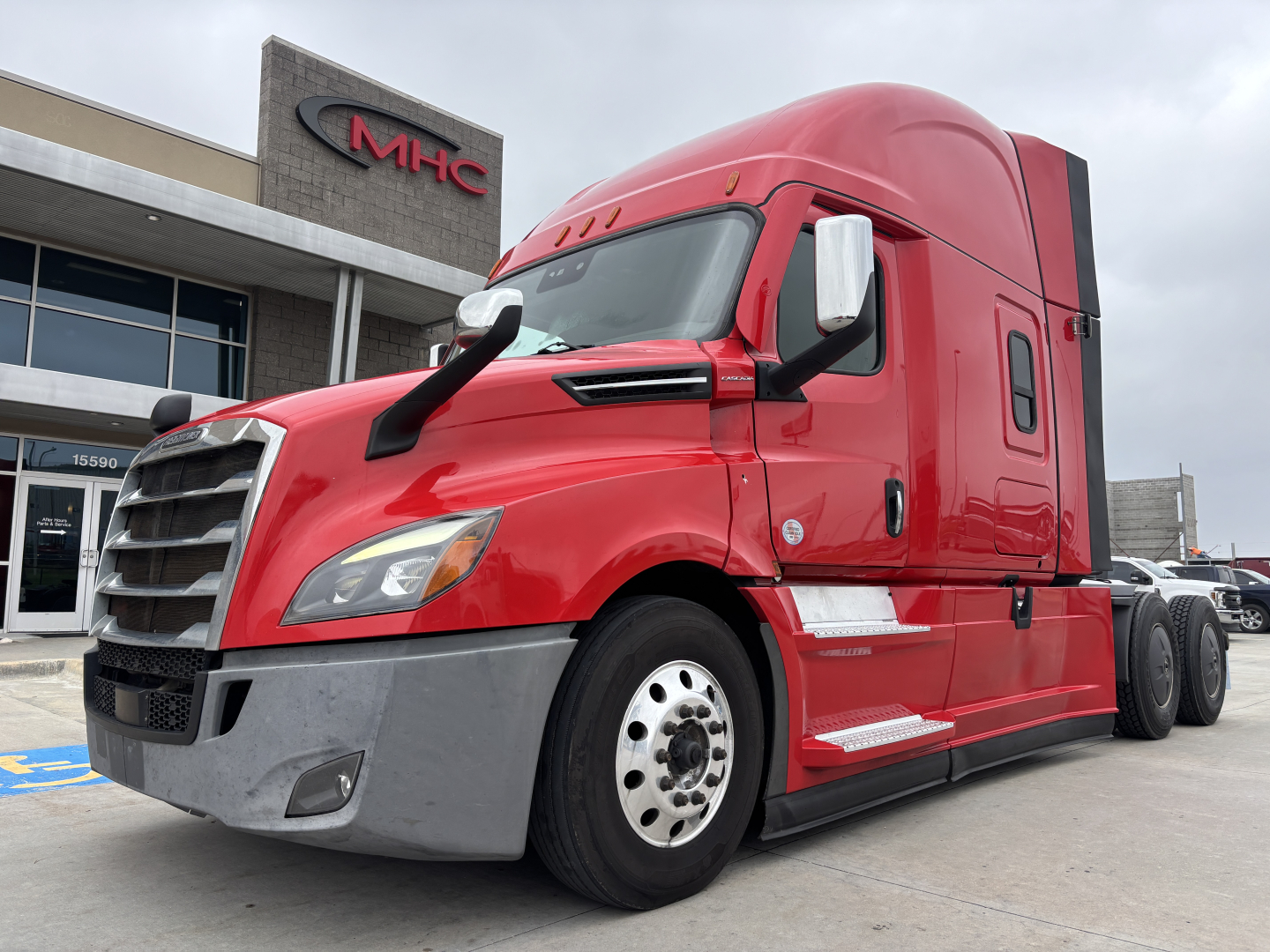 Red Freightliner PT126064ST tractor unit showing front left view with cab and dual rear wheels.