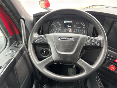 Freightliner PT126064ST interior with steering wheel and dashboard showing gauges and digital display.