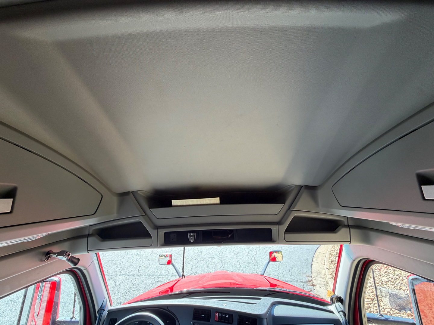 Kenworth T680 cabin interior roof view with front windshield and overhead console.