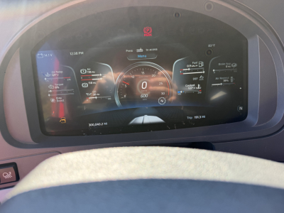 Kenworth T680 instrument cluster display in dashboard showing digital gauge readouts and warning icons.