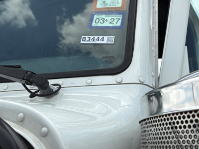 Peterbilt 389 cabin windshield with B3444 stock tag and VIN sticker visible on the glass