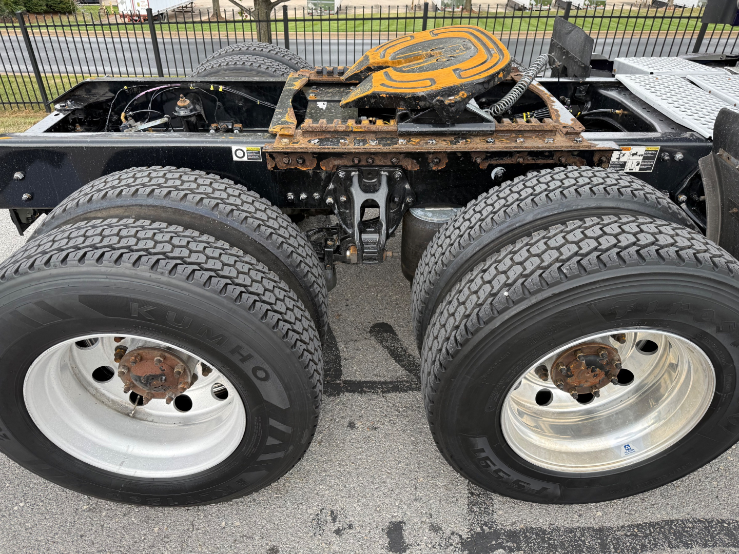 Kenworth T680 chassis showing dual rear axles with tires and fifth wheel coupling visible.