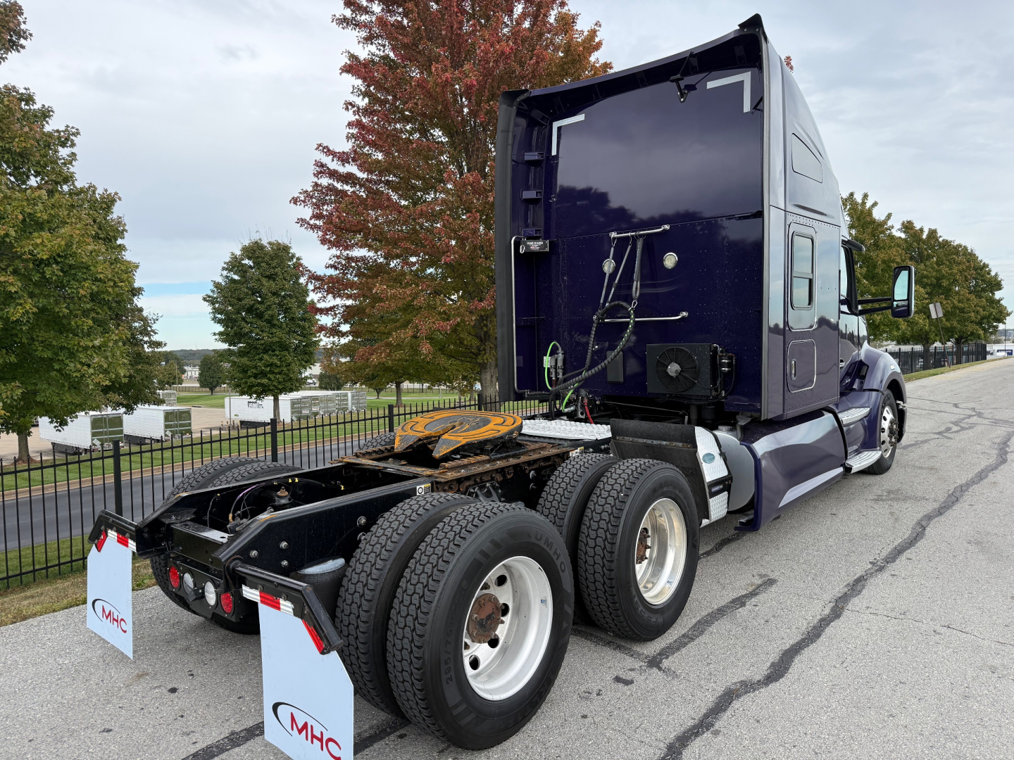 Kenworth T680 tractor rear and side view showing fifth wheel and dual rear axle setup with purple cab