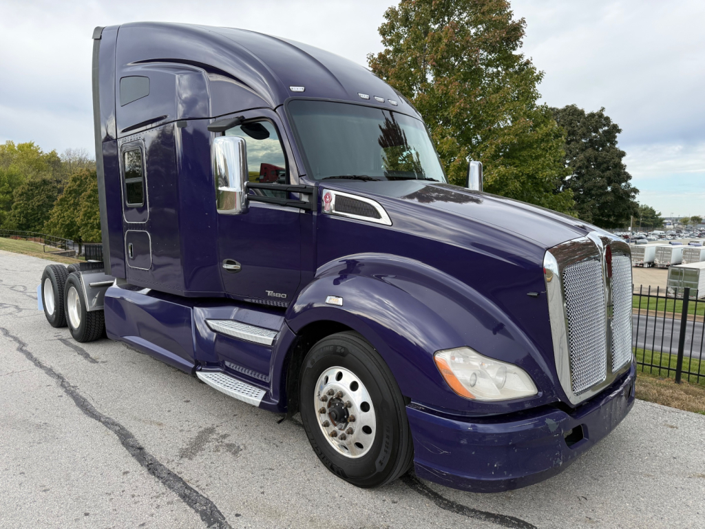 Kenworth T680 truck in dark purple with sleeper cab, side view showing front grille, chrome mirrors, and dual rear axles.