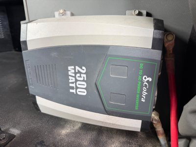 Truck battery isolator labeled 2500 WATT with GenGuard 60? brand sticker visible in engine bay area.