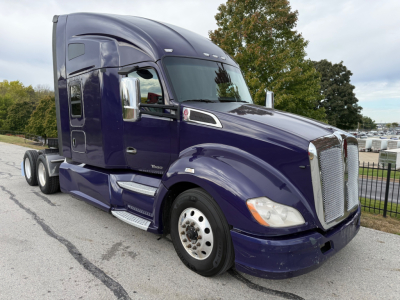 Kenworth T680 truck in dark purple with sleeper cab, side view showing front grille, chrome mirrors, and dual rear axles.