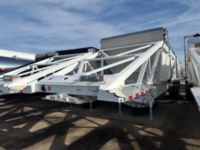 Cps air ride bottom dump trailer in a row of similar trailers with white frame and triangular support braces, landing gear visible.