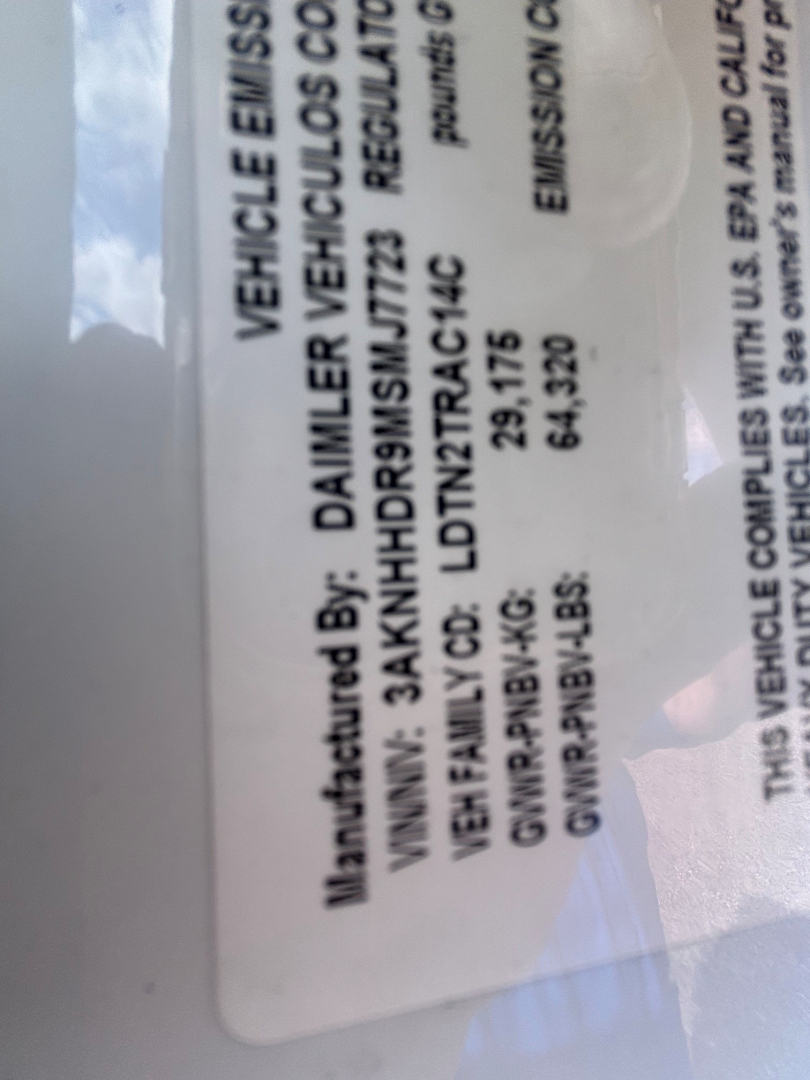 Label on Freightliner truck with VIN, stock number, category, and type details. Visible text includes 'VEHICLE EMISSIONS', '3AKNHHDR9MSMJ7723', 'B3460P', 'Category: Conventional Sleeper', 'Type: Trucks', 'NewUsed: Used'.