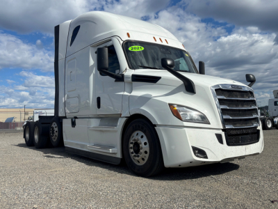 Freightliner CA-126 sleeper truck side/front view showing 2021 model sticker on windshield and chrome grille.