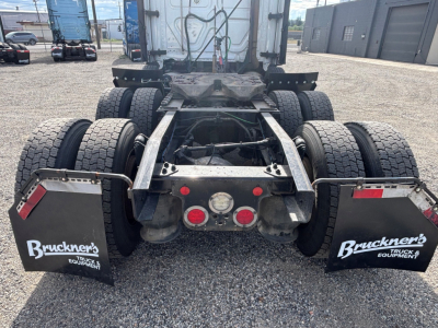 Rear view of a Freightliner CA-126 tractor showing dual rear axle twins, mud flaps labeled Bruckner's Truck Equipment, and spare wheel areas.